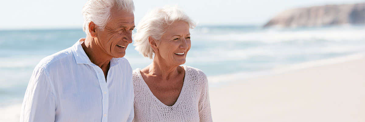Local Medicare insurance agent helping an older couple compare Medicare plan options, costs, doctors, hospitals, and prescription coverage in Virginia.